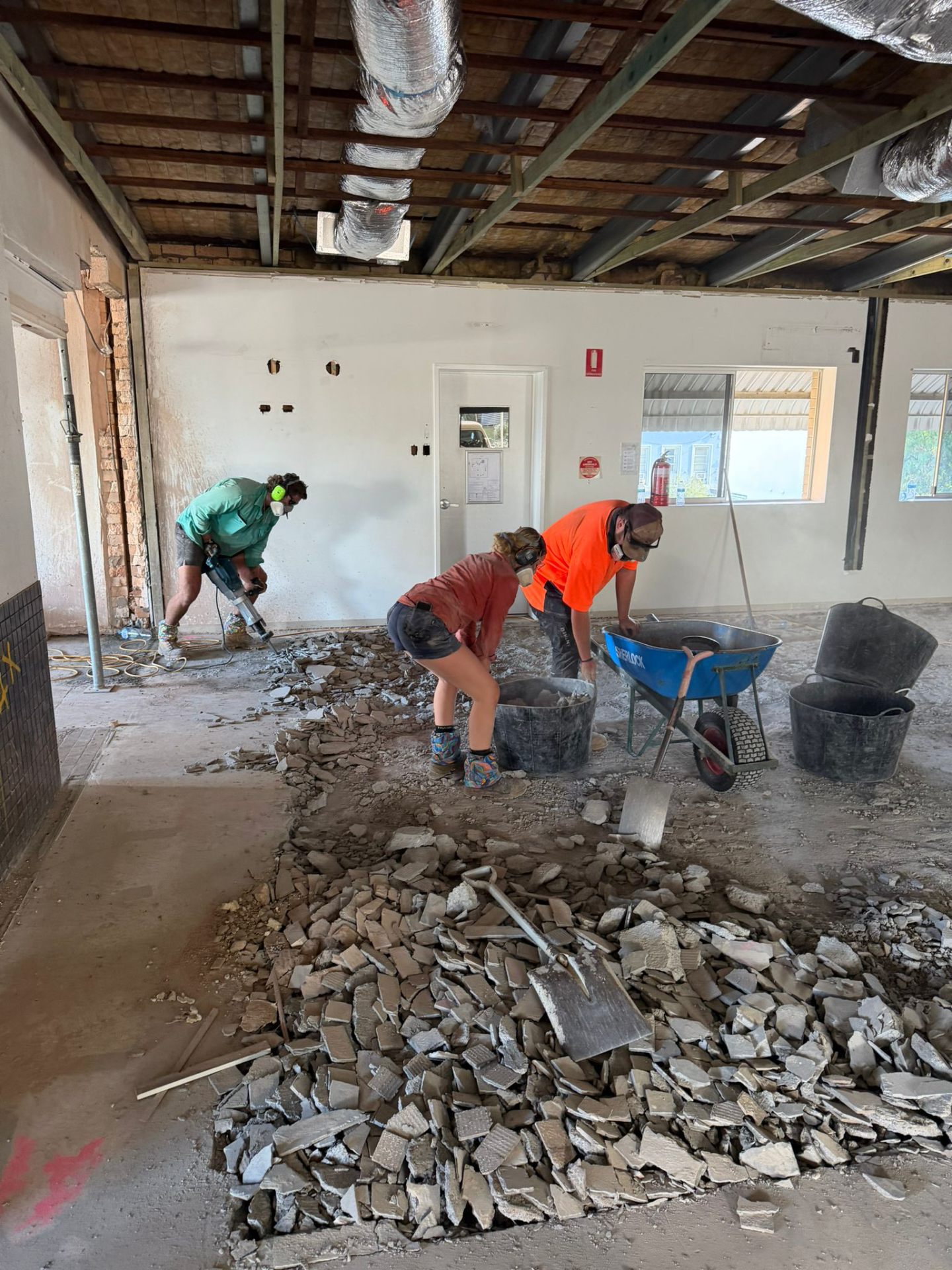Commercial strip-out in progress in Gympie, South East Queensland, with floor tiles being broken out